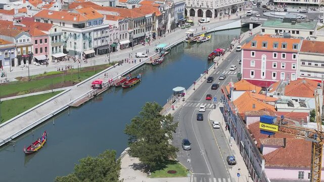 Beautiful aerial view of Aveiro city in Portugal. Aveiro Water canal of Ria de Aveiro with typical boats and tourists, cityscape in the background.