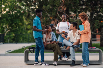 Full length of students on break talking and having coffee at campus.