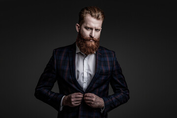 Fototapeta premium Man businessman in bespoke formalwear. Business man in elegant tailored suit. Formal tailored suit. Gentleman menswear. Bespoke suit. Bearded man in tailored formal menswear. Eveningwear ensemble