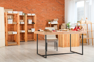 Workplace with shoes and tools in shoemaker's workshop