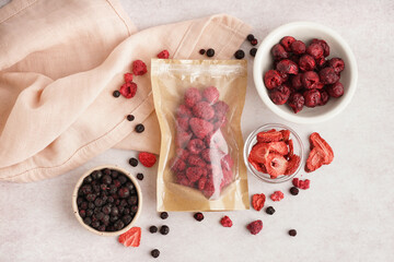 Composition with tasty freeze-dried berries on light background