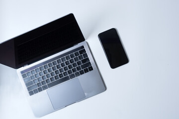 Flat lay photo of office desk with laptop, and smartphone with copy space background. Mockup