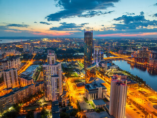 Yekaterinburg city and pond aerial panoramic view at summer or early autumn night. Night city in the early autumn or summer.