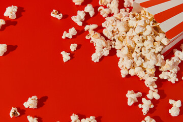 Striped box with popcorn on a red background