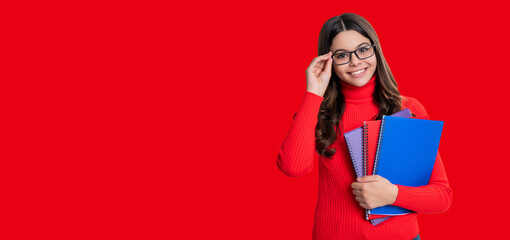 Fototapeta premium School education. Students life. Teen girl back to school. Knowledge day. Education in college. Girl student isolated on red. September 1. Copy space banner. Knowledge and education