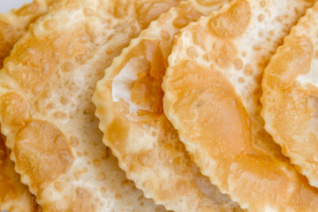Ciborek, close up of delicious golden brown fried dough showing texture and crispiness, traditional Turkish food.