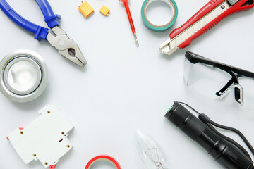 Frame made from electrician's tools on white background
