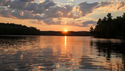 Fototapeta premium Golden Sunset Reflected in a Calm Lake.