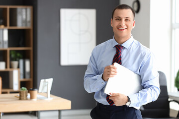 Male accountant with laptop in office