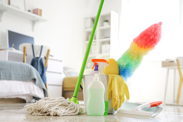 Cleaning supplies on floor in dorm room, closeup