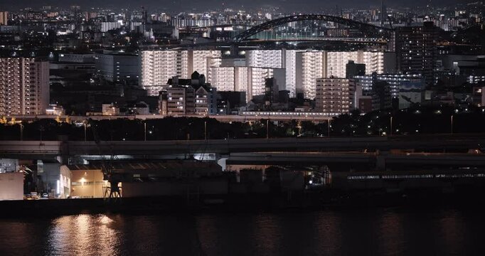 Tokyo city At night, bright buildings are reflected on the waters surface