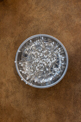 large pins in metal bowl