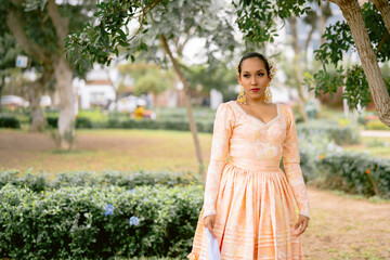 Latin dancer posing in a park wearing traditional dress