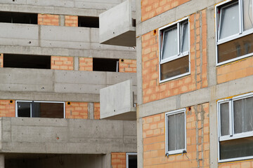 Dense development of new housing in Europe, multi-apartment panel buildings under construction, houses