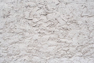 Rough plaster on the wall. The texture of sandy plaster on the facade.