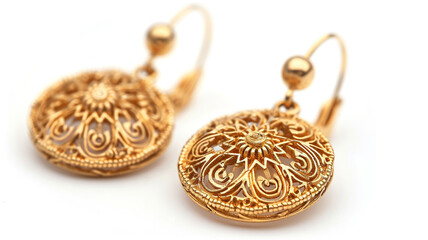 Ethnic lacy gold earrings isolated over white