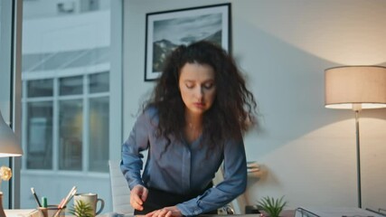 Corporate manager open laptop in evening office. Tired busy lady holding coffee
