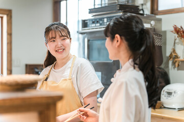 Obraz premium カフェ・レストランでアルバイトする若いアジア人女性（学生・大学生・高校生） 