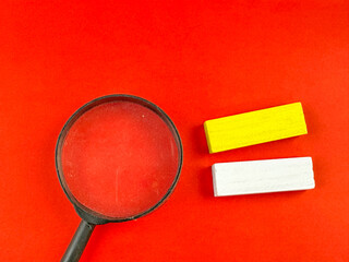 magnifier glass on red background for concept with two block with text space