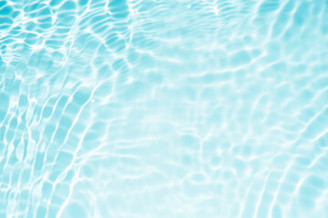 Blue water with ripples on the surface. Defocus blurred transparent blue colored clear calm water...