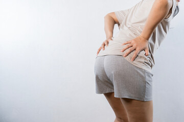 A woman holds his hands to the ass feeling pain. Hemorrhoids. Anus. Pain.