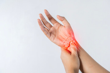 Closeup of male arms holding his painful wrist caused by prolonged work on the computer.