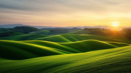 Stunning Sunset Over Rolling Green Hills with a Serene Landscape and Distant Mountains