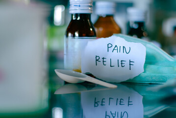 medical medicines in bottles, medical prescriptions, dark bottle on the table in the doctor's office with the hand writen of healthcare concept.