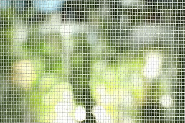 Insect screen for window against blurred background, closeup