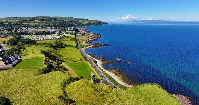 Aerial View of Red Bay Castle Cushendall Waterfoot on the Irish Sea Antrim Northern Ireland on a sunny day with a blue sky