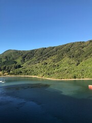 Green ride mountain salient to blue sea clear blue sky