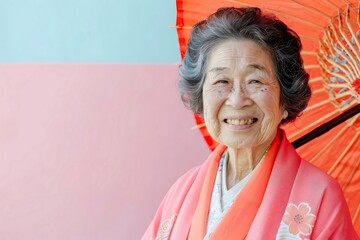 Elderly Asian woman with a bright smile holding a  58 3 woman, smiling, child, beauty, person, face, smile, people, hair, fashion, boy, one, happiness, expression, cheerful, colorful 