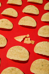 Crispy potato chips on a red background