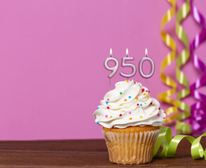 Birthday Cupcake With Candles Lit Forming The Number 950