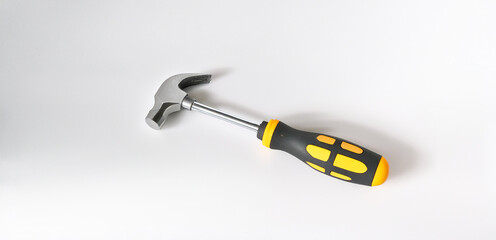 Yellow-handled claw hammer with a black grip, isolated on a white background.