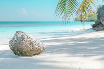 A large rock sits on the beach, with the ocean in the background