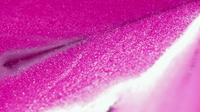 Abstract background. Shimmering liquid. Glitter lacquer flow. Blur sparkling particles polish emulsion pink fluid drip motion on pyramid surface.