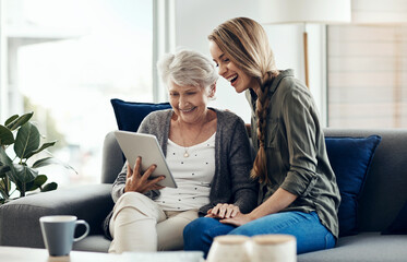 Tablet, relax and woman with senior mother in home for help with online blog, internet or...