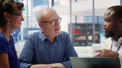 Middle aged people receiving financial advice on retirement planning and life insurance, focusing on increasing their savings with pension plans. Senior couple meeting with banker. Camera A.