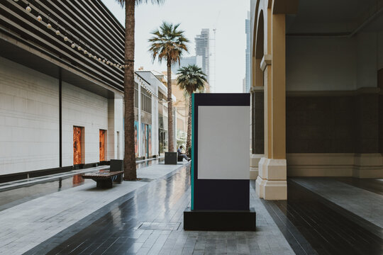 Blank signage board in urban park setting on the ground outside