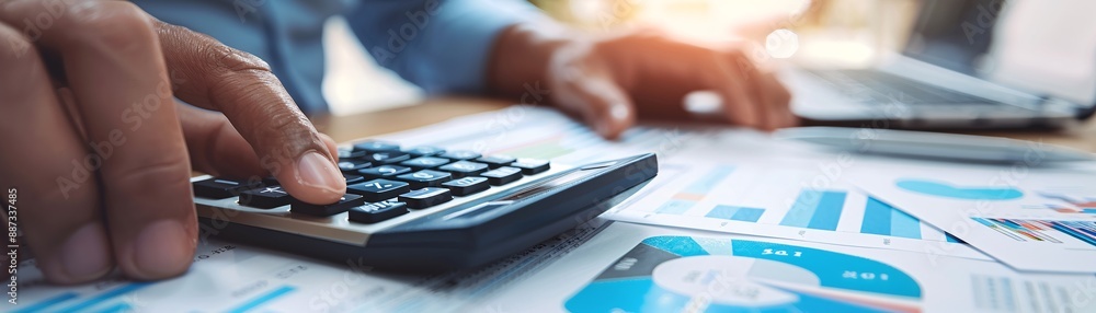Poster close-up of an advisor's hand using a calculator, emphasizing financial analysis and investment plan