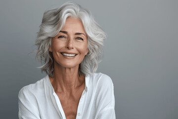 Fototapeta premium Happy and Stylish Senior Woman with Grey Hair Smiling in White Shirt