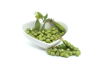 Fresh green peas in a heart-shaped bowl isolated on white background