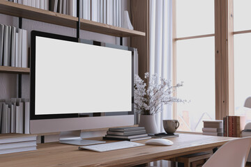 Fototapeta premium Contemporary home workspace with blank computer screen, shelves with books, natural light