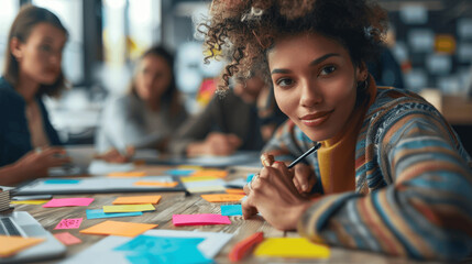 Collaborative Business Meeting with Diverse Team Brainstorming Using Sticky Notes and Digital Devices on Wooden Table