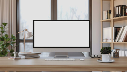 Fototapeta premium Contemporary home workspace with blank computer screen, shelves with books, natural light