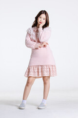 Portrait of Asian cute cheerful teen girl wearing light pink dress, stylish model woman with happy and cool sweet smile posing isolated on white background, Teenage and youth fashion