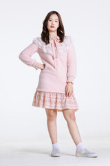 Portrait of Asian cute cheerful teen girl wearing light pink dress, stylish model woman with happy and cool sweet smile posing isolated on white background, Teenage and youth fashion
