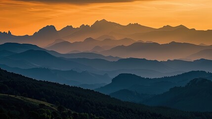 Obraz premium Mountain silhouettes in sunset light