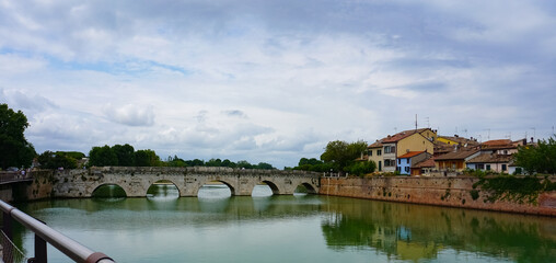 Obraz premium Historical roman Tiberius Bridge over Marecchia river in Rimini, Italy